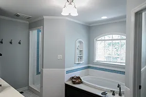 bathroom displaying a tub and partial shower